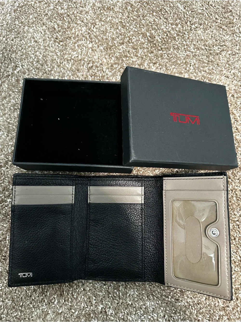 Tumi Black Leather Wallet with Light Trim and Metal Logo